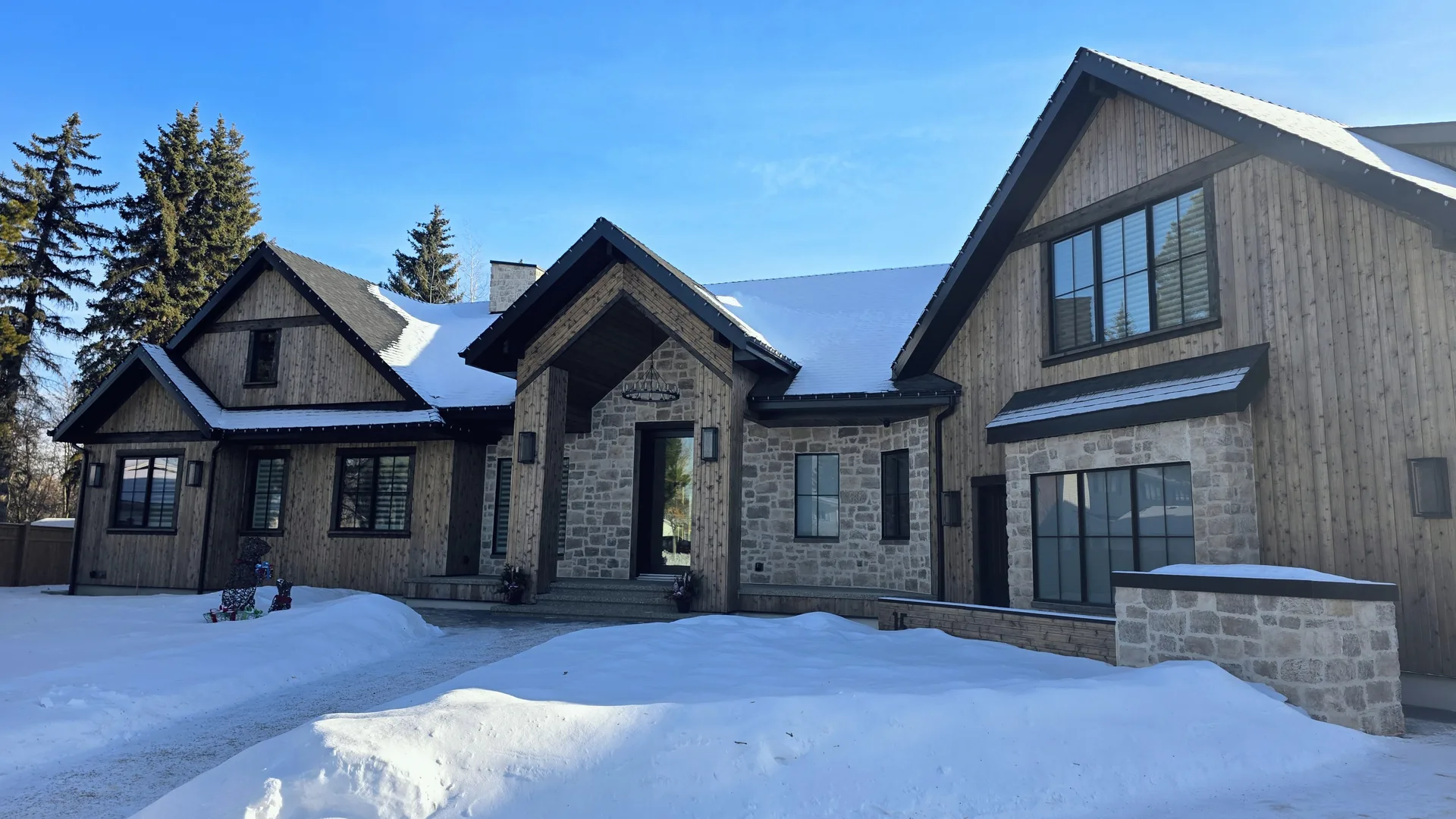 Premium stone-and-wood Edmonton home with a Royal Roofing Edmonton roof