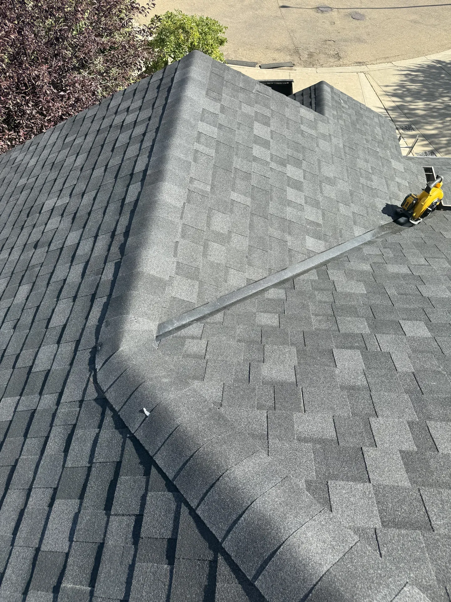 Gray shingle peak detail with coil nailer