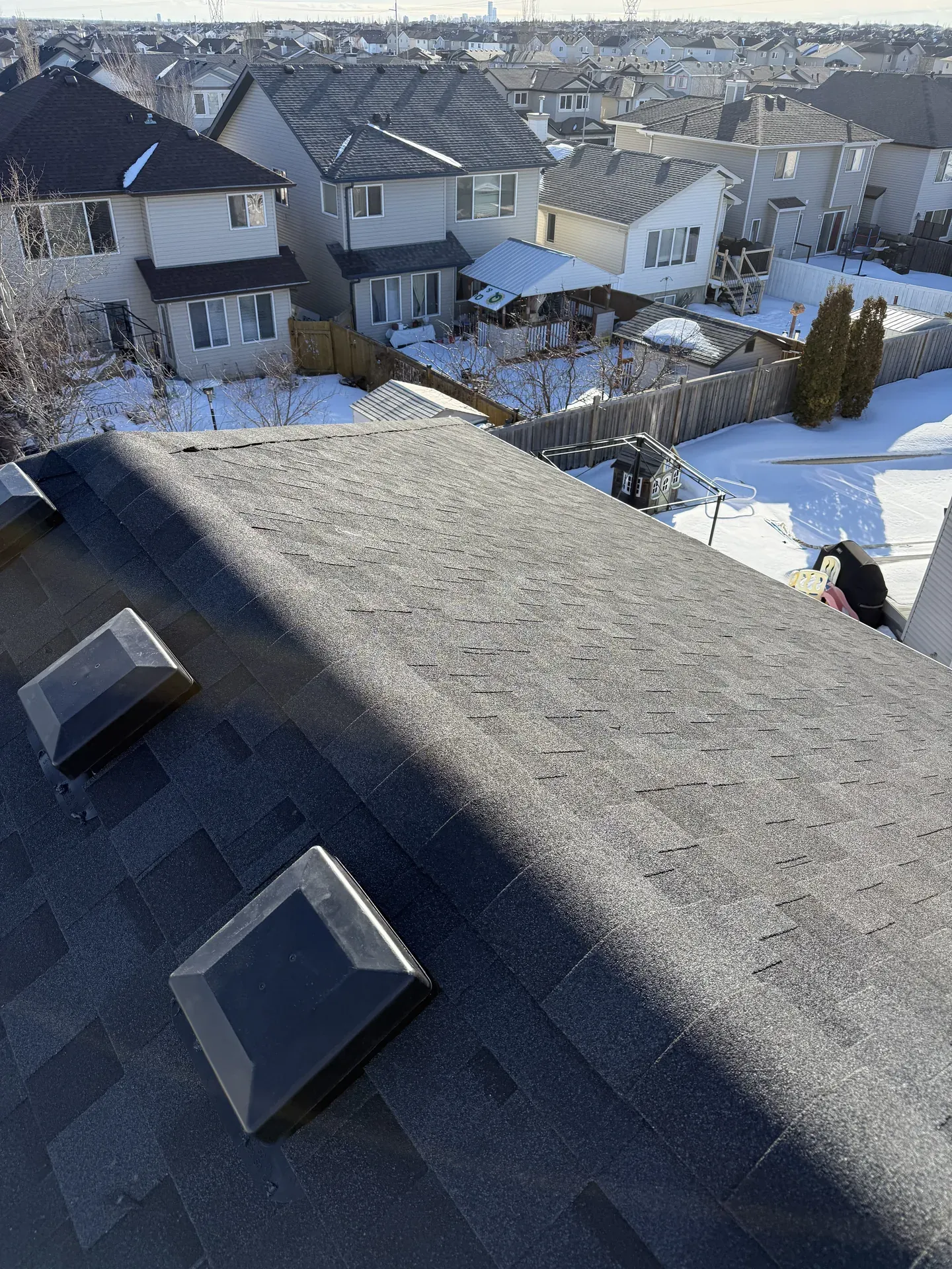 Winter gray shingle roof with an Edmonton neighbourhood view