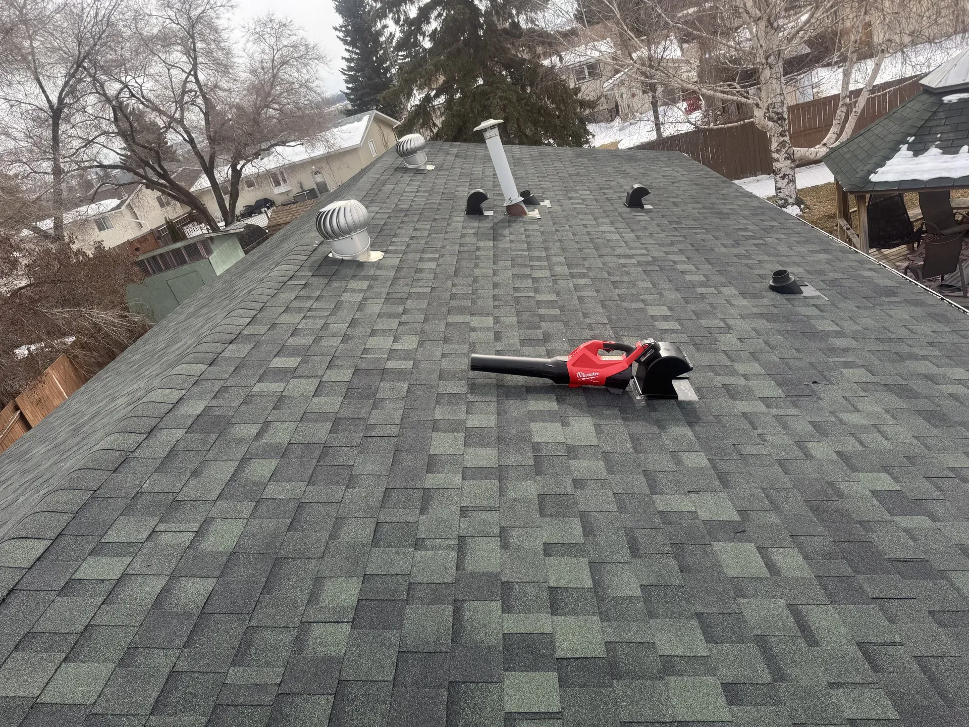 Winter shingle roof clean-up with a leaf blower